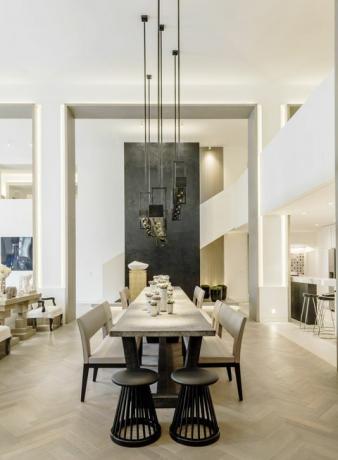 Kelly hoppen pusdienu galds ar lielām piekarināmām gaismām